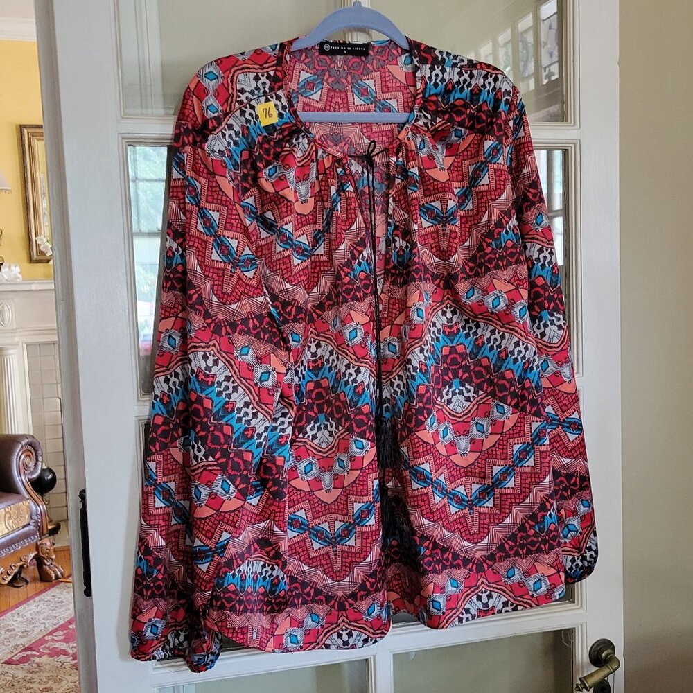 blouse featuring a dynamic mix of geometric and abstract patterns